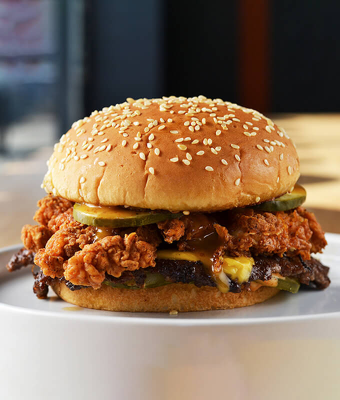 Moother Clucker Sandwich is a 4oz beef patty and a 4oz chicken breast with a pickle and american cheese